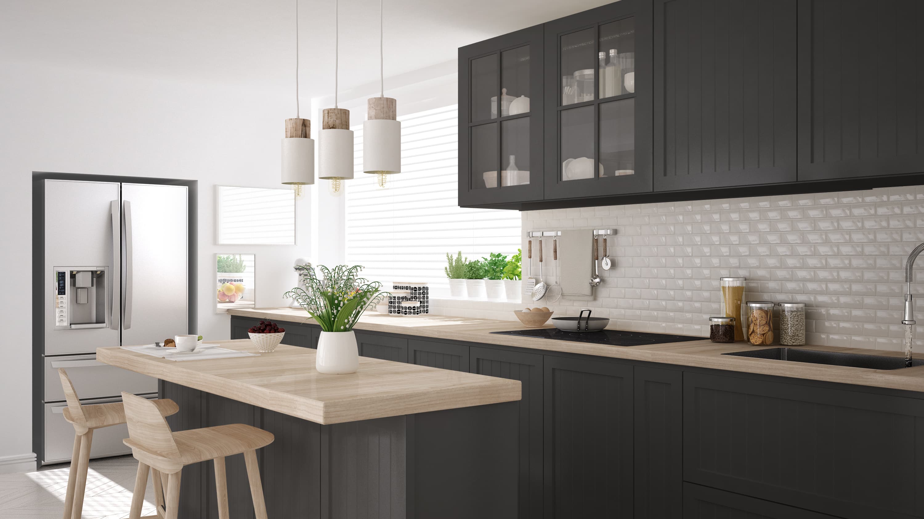 Kitchen with white walls and black cabinets with a sun filled window and green herbs in white pots sitting on the window sill