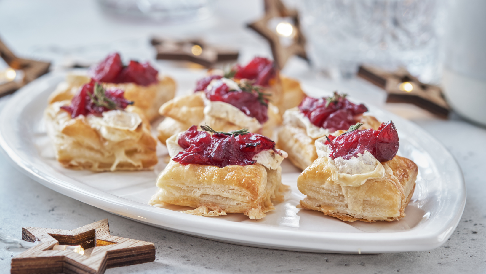 Holiday appetizers with cranberry sauce, brie cheese and thyme